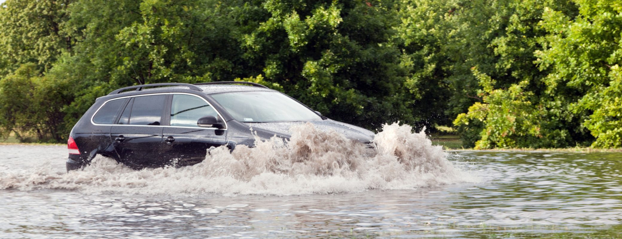 GDANSK, POLAND - July 28: Car trying to drive against flood on the street on July 28, 2015 in Gdansk, Poland. Storms and heavy rains hit many parts of Poland and Europe
